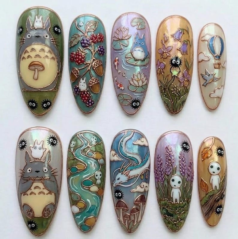 May include: A set of ten intricately designed nail art pieces. Each nail features a different design, including Totoro, berries, koi fish, flowers, and a hot air balloon. The nails are oval-shaped with a glossy finish and detailed artwork.