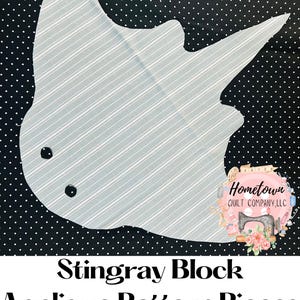 Peut inclure: Un motif d'appliqué en tissu de raie blanche et bleue en forme de raie manta pour la courtepointe. Le motif est sur un fond noir avec des pois blancs. Le texte "Hometown Quilt Company, LLC" est visible dans le coin inférieur droit de l'image.