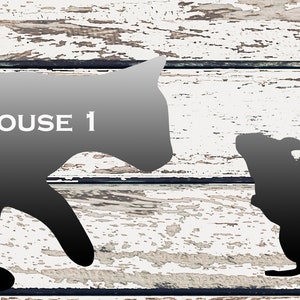 May include: Black and white silhouette of a cat and mouse with a hammer. The cat is larger than the mouse and is walking towards the mouse. The text "CAT AND MOUSE 1 DXF" is written on the cat's body.