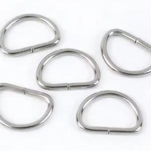 May include: Five silver-colored D-rings are arranged on a white background. Each D-ring is made of metal and has a hinged design, allowing it to open and close. The rings are evenly spaced and appear to be new.