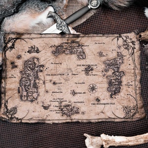 May include: A vintage-style map with handwritten text and illustrations of islands and seas. The map is surrounded by animal furs, feathers, and antlers.