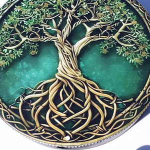 May include: Circular decorative piece featuring a detailed Tree of Life design. The tree has intertwined roots, a textured trunk, and leafy branches. The background is a deep teal color, and the border has an intricate Celtic knot pattern.