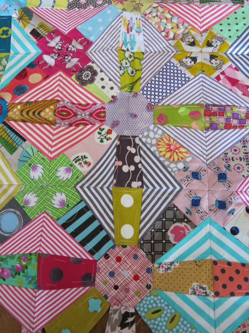 May include: A colourful patchwork quilt featuring a range of fabrics and patterns, including stripes, polka dots, and floral designs. The quilt is made up of squares and diamonds, and the colours are bright and cheerful.