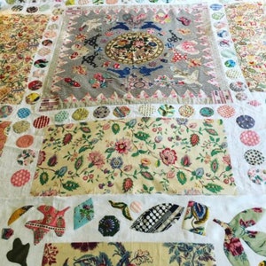 May include: A vintage patchwork quilt featuring a variety of floral patterns, geometric shapes, and colours. The quilt is made up of different fabrics, including cotton and linen. The quilt is a beautiful example of traditional quilting.