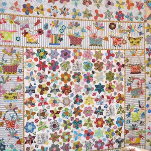 May include: A colorful quilt with a patchwork design featuring stars, flowers, and baskets. The quilt is made with a variety of fabrics in bright colors and patterns.