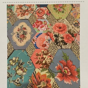 May include: A colorful quilt pattern called "Casablanca" designed by Margaret Sampson George. The pattern features a hexagonal design with floral fabric in shades of pink, red, blue, green, and yellow.