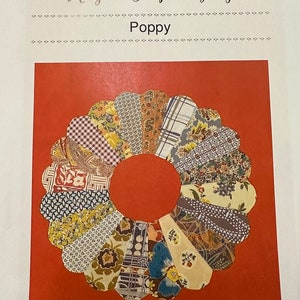 May include: A colourful fabric poppy flower with a red background. The title "Take an Element" and the name "Margaret Sampson George" are printed above the flower. The word "Poppy" is printed below the flower.