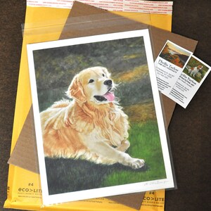 May include: A watercolor painting of a golden retriever dog lying down in a grassy field. The dog is looking up and has its tongue sticking out. The painting is signed by the artist.