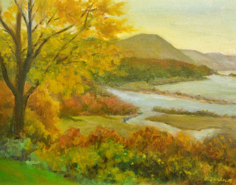 A fine art print from an original oil painting of a scene with a riot of Fall colors seen from Boscobel Historic Restoration in Garrison, NY. You can see the Hudson River and sections of Constitution Marsh marshland along the waterfront below the property. The river is light blue and the valley is green with yellow and orange and red in the trees and grassy areas in the marsh. The sky is light blue and there are some mountains visible in the background.