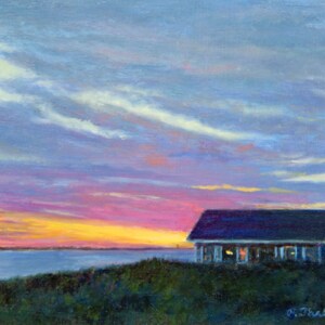 May include: An oil painting depicts a coastal scene at sunset. A small blue house sits on a grassy dune, overlooking a calm body of water. The sky is filled with vibrant colors of pink, orange, and blue, with soft clouds.