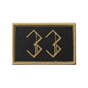May include: Black rectangular patch with the number "33" embroidered in gold thread. The patch has a gold border and a textured appearance. The number is stylized with angular lines.