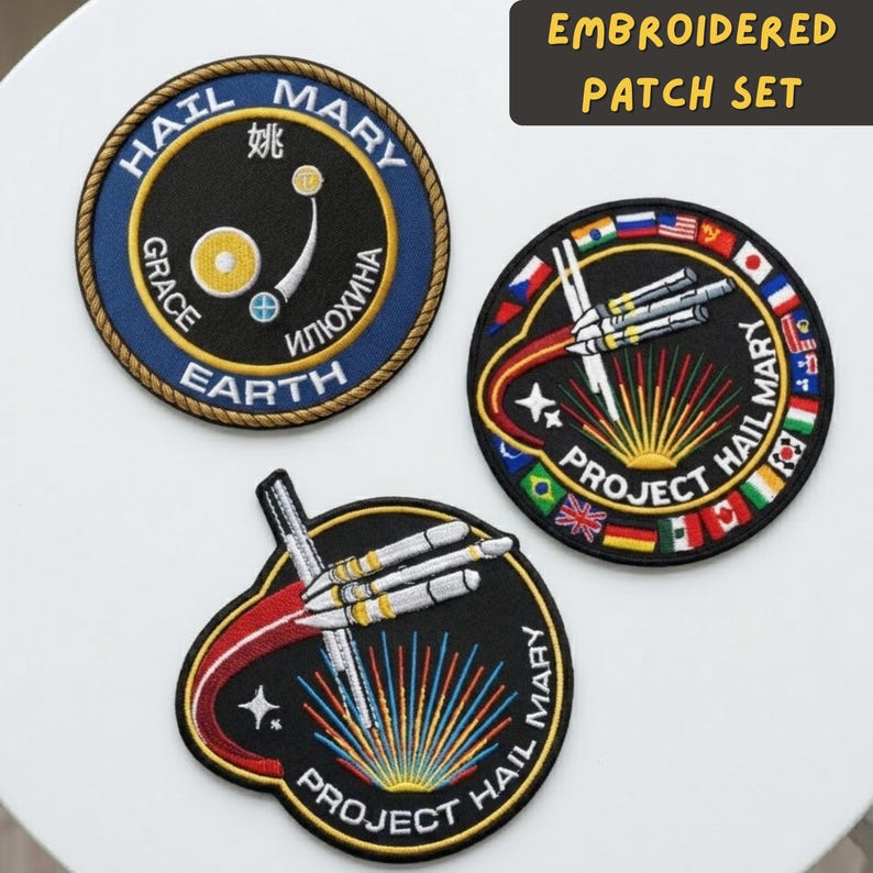 May include: Embroidered patch set featuring three unique designs. One patch is circular with text and a graphic, another features a rocket design with flags, and the third has a rocket design with the text "Project Hail Mary".