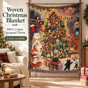 May include: A woven cotton jacquard throw blanket featuring a festive holiday scene with a decorated Christmas tree, a fireplace, a polar bear, foxes, and wrapped gifts. The text reads Woven Christmas Blanket, 100% Cotton Jacquard Throw, 3 Sizes Available.