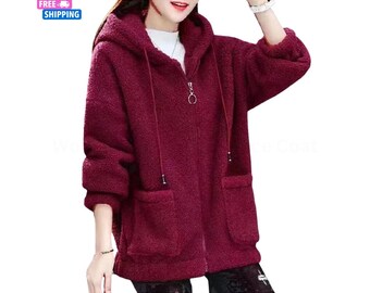 May include: A burgundy hooded jacket with a zip-up front and two front pockets. The jacket has a soft, textured appearance and a drawstring hood. The image also includes the text "FREE SHIPPING" in a blue box.