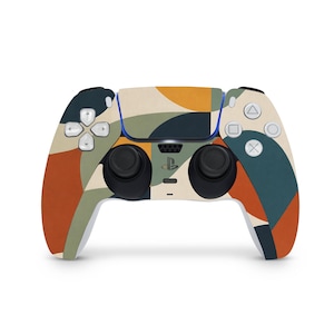 Könnte beinhalten: Ein PlayStation 5-Controller mit einem farbenfrohen, abstrakten Design. Der Controller hat ein Muster aus orangefarbenen, grünen, beigen und blauen Formen. Die Knöpfe und Joysticks sind schwarz, die Richtungstasten weiß.