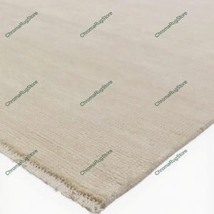 May include: Beige rectangular rug with a textured surface. The rug has a fringe on one edge and is displayed at an angle. The ChromaRugStore logo is visible in the corners.