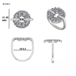 May include: A silver ring with a circular design encrusted with small, clear gemstones. The ring features a band and a connecting bar. The ring size is US 6.5, and the circular design is 15.00 mm in diameter.