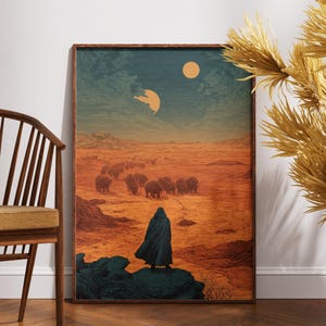 May include: A rectangular framed wall art print featuring a science fiction landscape with a lone figure in a dark cloak standing on a rock, overlooking a vast orange desert with a herd of creatures under a sky with two circular celestial bodies.