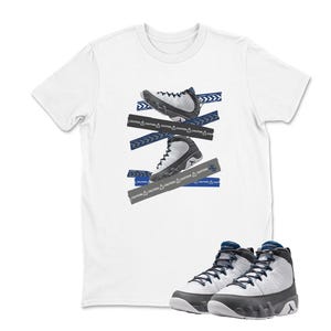 May include: White t-shirt featuring a graphic of two sneakers with blue and gray accents, and caution tape. The shirt is paired with a matching pair of sneakers with white, gray, and blue details.