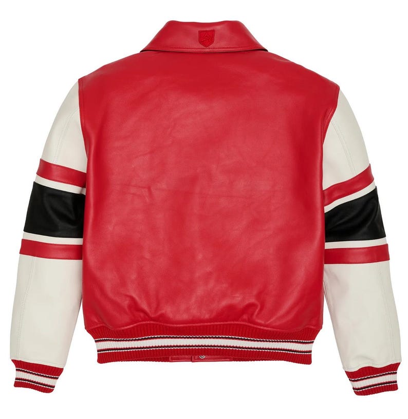 May include: Red and white varsity jacket with black stripes on the sleeves. The jacket has a red body, white sleeves, and a ribbed hem and cuffs with red and white stripes. A small emblem is on the back collar.