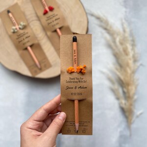 There are flowers and a pencil with seeds on the card.