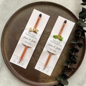 There are flowers and a pencil with seeds on the card.