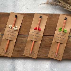 There are flowers and a pencil with seeds on the card.