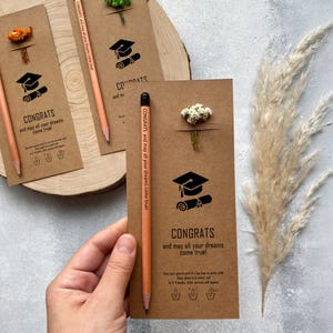 There are flowers and a pencil with seeds on the card.