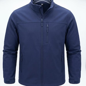 May include: A solid navy blue softshell jacket featuring a stand-up collar, a full-length front zip, and long sleeves with adjustable hook-and-loop cuffs. The garment includes one vertical zipped chest pocket and two lower zipped side pockets.