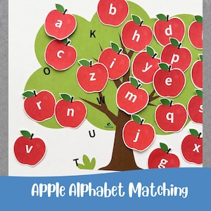 May include: An educational wall chart featuring a brown tree with green foliage and numerous red apple cutouts. Each apple displays a lowercase white letter of the alphabet. Additional black letters are printed on the tree branches.