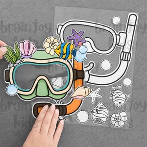 以下が含まれることがあります： オレンジ色のシュノーケルが付いたカラフルな水中マスク。緑の海藻、ピンクの貝殻、渦巻き貝、黄色と青の魚、紫のヒトデ、青い泡で装飾されています。隣には黒と白の輪郭線で描かれたステッカーシートが添えられています。