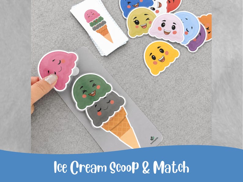 May include: A collection of colorful ice cream scoop matching game pieces. The image features various ice cream scoops with smiling faces, along with a matching cone. The text "Ice Cream Scoop & Match" is at the bottom of the image.