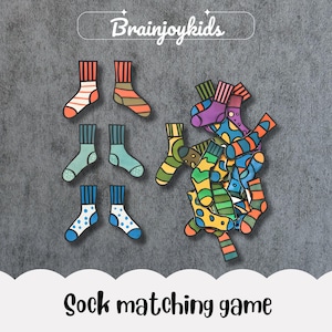 May include: A collection of colorful, illustrated socks arranged on a gray background. The socks feature various patterns and colors, including stripes, polka dots, and geometric designs. The text "Brainjoykids" and "Sock matching game" are also present.