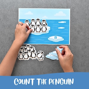 Puede incluir: Un conjunto de actividades educativas que muestra una escena de océano azul con un gran iceberg y el número 8 impreso en un témpano más pequeño. Incluye varias figuras de pingüinos troqueladas y formas adicionales de hielo.