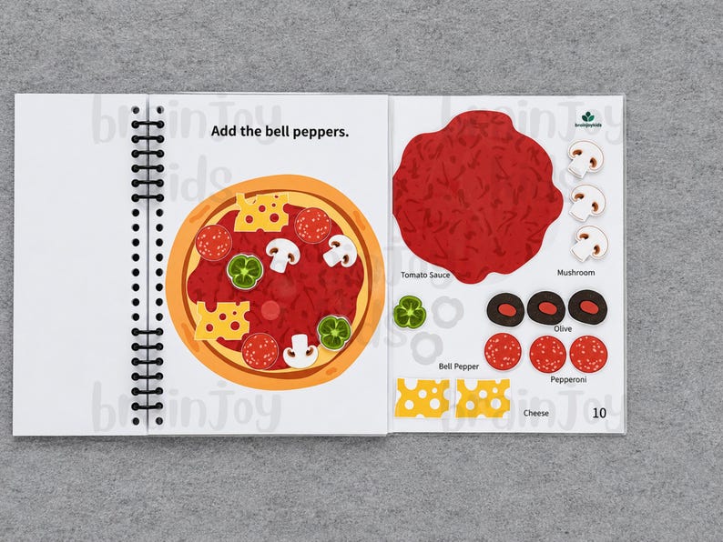 May include: A spiral-bound children's activity book open to a pizza-making page. The left page shows a pizza with toppings. The right page has tomato sauce, mushrooms, olives, bell peppers, pepperoni, and cheese. Text reads "Add the bell peppers."
