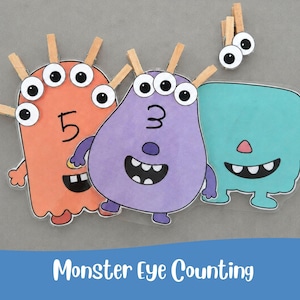 Peut inclure: Trois découpes de monstres colorés avec des chiffres imprimés et des pinces à linge en bois attachées. Le monstre orange porte le chiffre 5, le monstre violet le chiffre 3 et le monstre bleu sarcelle est uni. Deux yeux mobiles sont sur une pince.