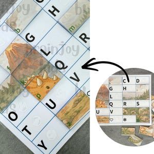 May include: A dinosaur-themed puzzle game with a grid of letters and images. The puzzle features a triceratops, volcano, and landscape illustrations. The game includes individual puzzle pieces and a reference guide. The letters A, E, G, L, Q, O, T, U, V, and Y are visible.