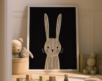May include: A framed black and white illustration of a rabbit with vertical striped details. The artwork is displayed in a child's room, surrounded by toys, including stuffed animals and wooden blocks. The overall theme is a nursery or children's room decor.