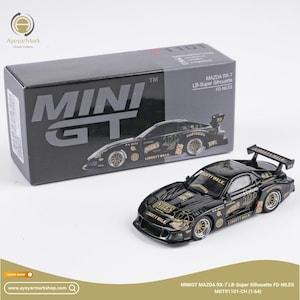 May include: A black Mini GT Mazda RX-7 LB-Super Silhouette FD-NILES model car with gold accents and the text "LIBERTY WALK". The model car is displayed next to its black box.