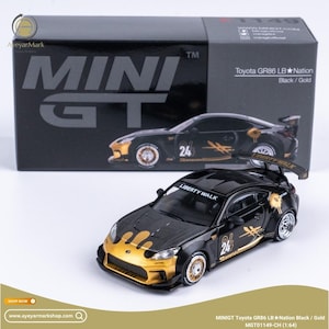 May include: A black and gold Mini GT Toyota GR86 LB Nation diecast model car. The model features gold accents, the number 24, and the text "LIBERTY WALK". The box behind the car also displays the car's image and the text "MINI GT".