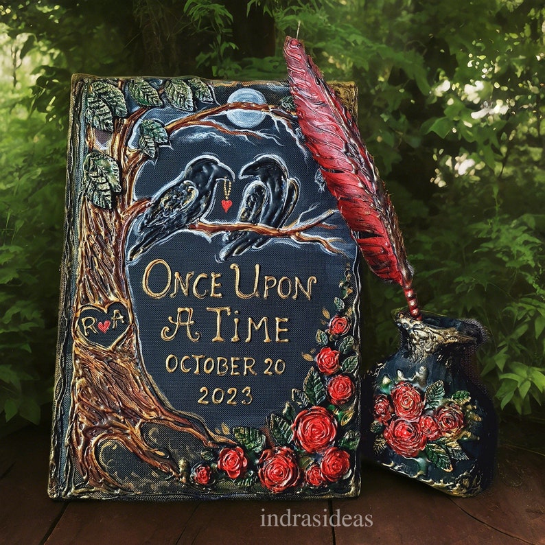May include: A black and gold wedding invitation with a dark background and a whimsical illustration of two ravens perched on a branch. The text reads "Once Upon A Time" with the date "October 20, 2023".