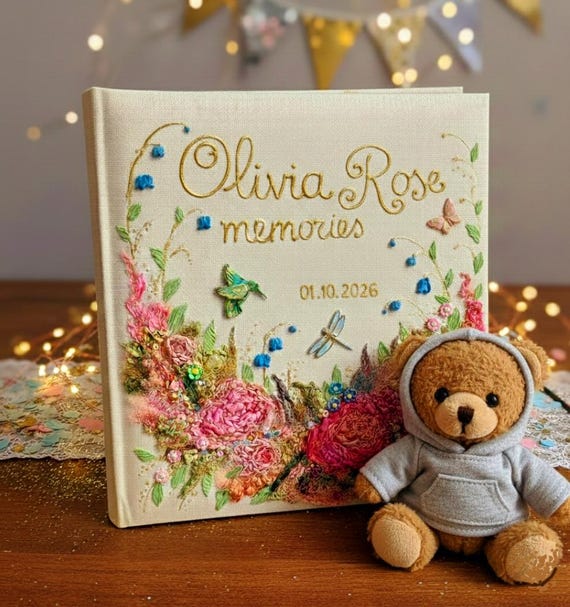 A baby photo album covered in hand-stitched ribbon embroidery flowers — genuinely labor-intensive craft that no algorithm can replicate.