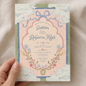 May include: A rectangular baptism invitation card featuring a pale pink striped background with a central scalloped frame. The design includes blue ribbons, white doves, green vines, and colourful flowers. Text details include the name Rebecca Miles, the date 18 October 2016, and the location Church of St. Patrick.