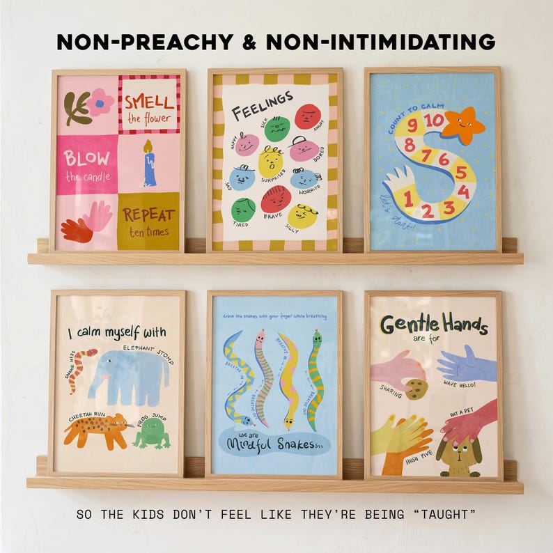 May include: Six framed art prints displayed on a wooden shelf. The prints feature colourful illustrations and text, including phrases like "Feelings," "Count to Calm," and "Gentle Hands." The overall theme is educational and child-friendly.