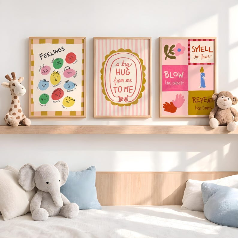 May include: Three framed art prints with text and illustrations. One print says "FEELINGS" with colorful faces. Another says "a big HUG from me TO ME". The third says "SMELL the flower, BLOW the candle, REPEAT ten times".
