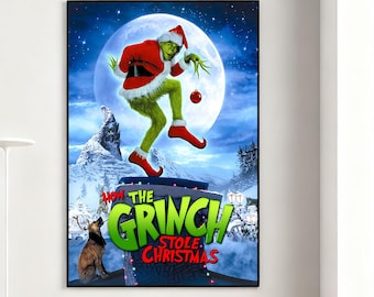 May include: A framed poster featuring the Grinch in a Santa suit, holding a Christmas ornament. The Grinch is depicted against a snowy mountain backdrop with a full moon. The poster's title reads "How the Grinch Stole Christmas."