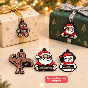 May include: Five Christmas-themed ornaments featuring a gingerbread person, Santa Claus, a muscular gingerbread person, and a snowman. The ornaments display text including "Für Leon von Oma," "Frohe Weihnachten, wünschen Oma & Opa," "Für Max," and "Frohe Weihnachten."