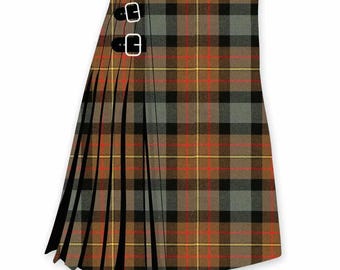 May include: A pleated kilt featuring a brown, black, grey, and red tartan plaid pattern. The garment includes two black leather straps with silver-toned metal buckles on the side for an adjustable fit, showcasing a traditional wrap-around design.
