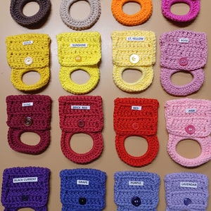 May include: Set of 15 crocheted dishcloths in various colors, each with a different color label. The dishcloths are made with a textured stitch and have a loop for hanging.