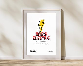 Może przedstawiać: Oprawiony wydruk artystyczny z napisem "SHE'S ELECTRIC" w kolorze czerwonym i czarnym, z żółto-czarną grafiką błyskawicy. Poniżej tekst "CAN I BE ELECTRIC TOO?" oraz nazwa zespołu "OASIS." i rok "EST.1991."